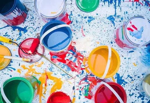 Open paint cans in red, blue, yellow and green